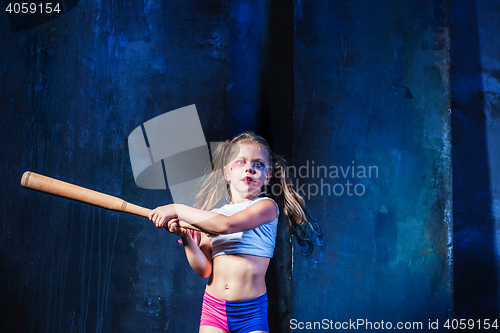 Image of Halloween theme: Girl with baseball bat ready to hit