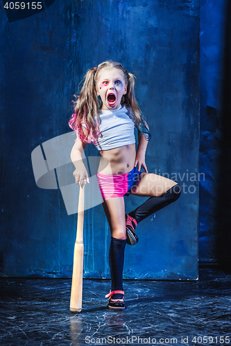 Image of Halloween theme: Girl with baseball bat ready to hit