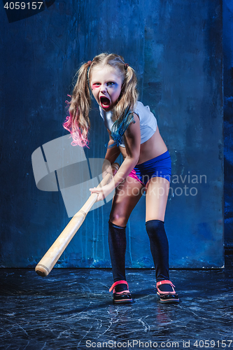 Image of Halloween theme: Girl with baseball bat ready to hit