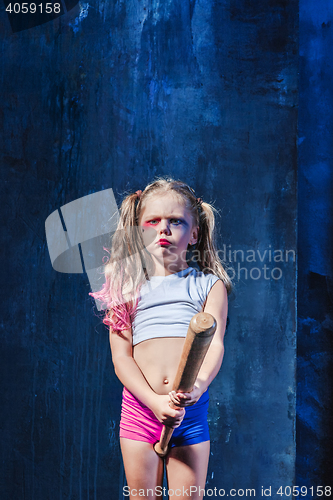 Image of Halloween theme: Girl with baseball bat ready to hit