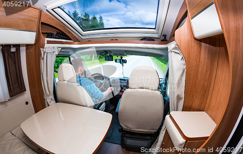 Image of Man driving on a road in the Camper Van