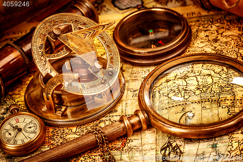 Image of Vintage magnifying glass lies on an ancient world map