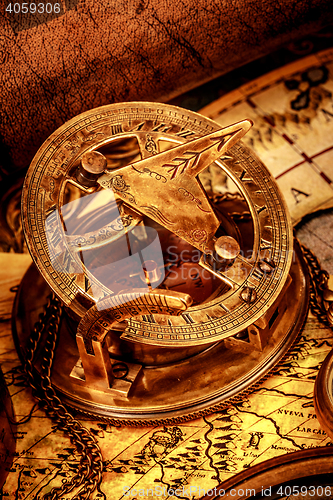 Image of Vintage compass lies on an ancient world map.