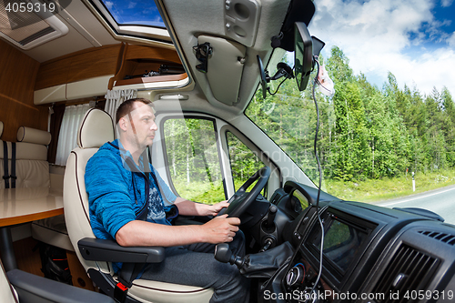 Image of Man driving on a road in the Camper Van