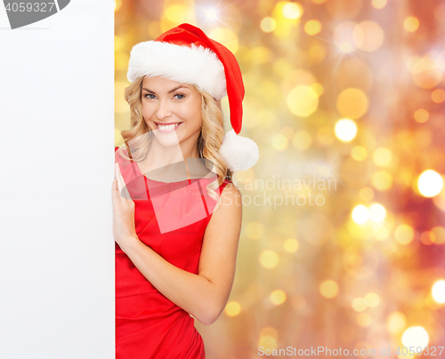 Image of woman in santa helper hat with blank white board