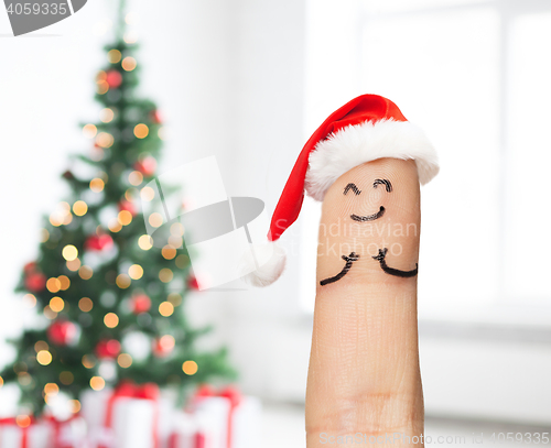 Image of close up of one finger in santa hat