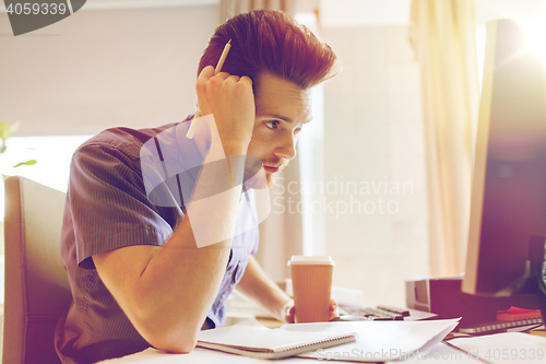 Image of creative male office worker with coffee thinking