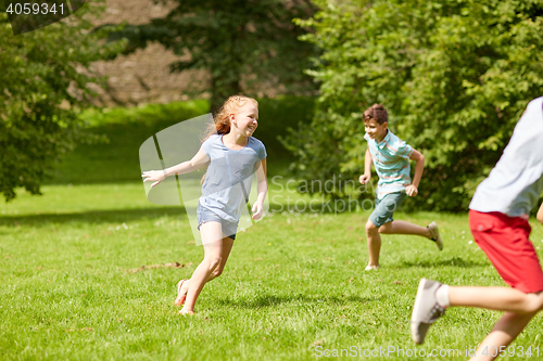 Image of happy kids running and playing game outdoors