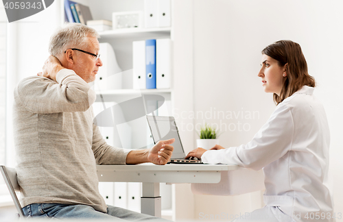 Image of senior man and doctor with tablet pc at hospital