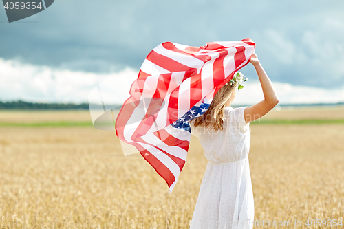Image of happy woman with american flag on cereal field