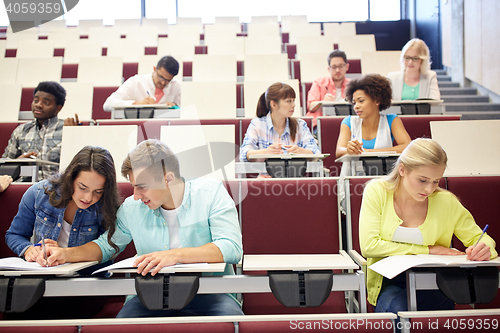 Image of group of students with notebooks at lecture hall