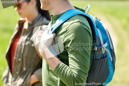 Image of close up of couple with backpacks hiking outdoors