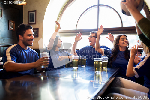 Image of football fans with beer celebrating victory at bar