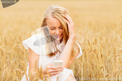 Image of happy woman with smartphone and earphones