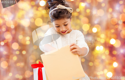 Image of smiling little girl with gift box