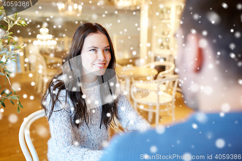 Image of happy couple talking at cafe or restaurant