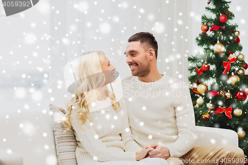 Image of happy couple at home with christmas tree