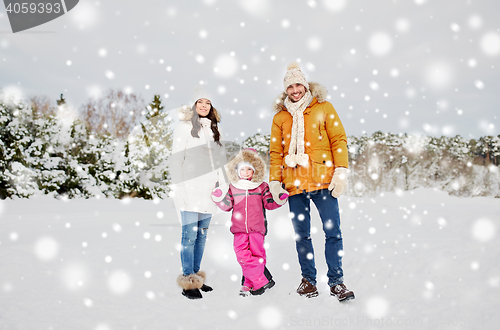 Image of happy family with child in winter clothes outdoors