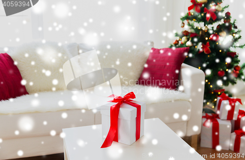 Image of close up of christmas gift box on table at home