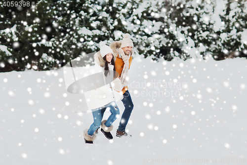 Image of happy couple running over winter background