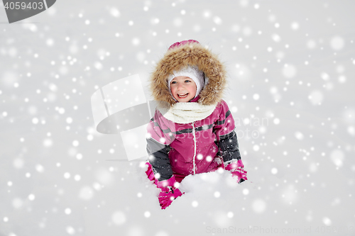 Image of f happy little child or girl with snow in winter