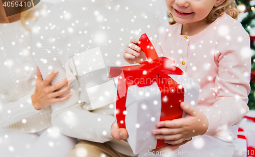 Image of close up of mother and child girl with gift box