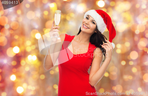 Image of beautiful sexy woman in santa hat and red dress