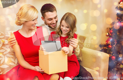 Image of smiling family with tablet pc