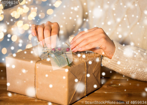 Image of close up of woman with christmas gift or parcel