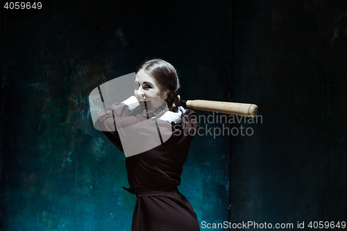 Image of Portrait of a young girl in school uniform as killer woman