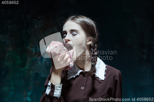 Image of Bloody Halloween theme: crazy girl with raw meat