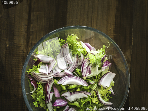 Image of bowl of real salad in on a wooden table