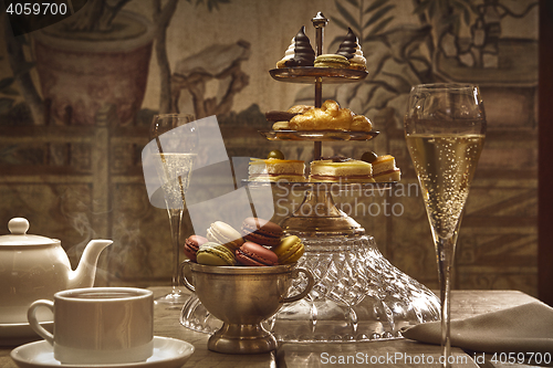 Image of luxury afternoon hot tea with champagne and macaroons