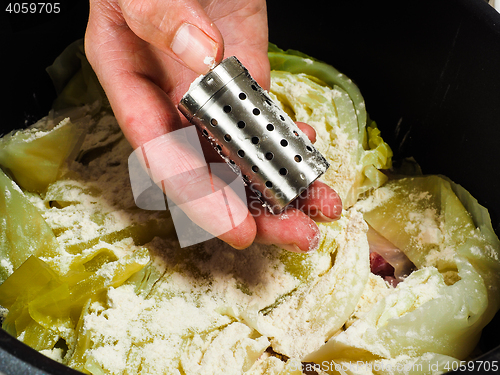 Image of Chef preparing a traditional norwegian dish, lamb and cabbage wi