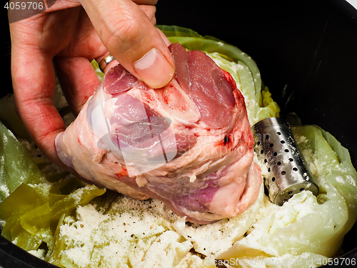 Image of Chef preparing a traditional norwegian dish, lamb and cabbage wi