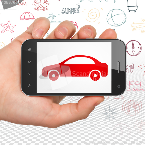Image of Vacation concept: Hand Holding Smartphone with Car on display