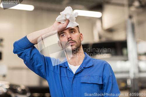 Image of tired auto mechanic man or smith at car workshop