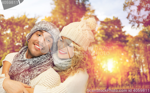 Image of happy couple in warm clothes over autumn