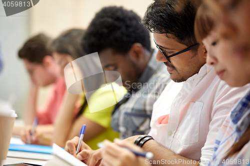 Image of group of international students writing at lecture