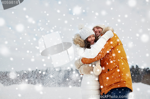 Image of happy couple hugging and laughing in winter