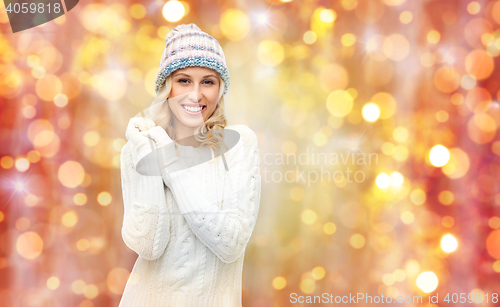 Image of smiling young woman in winter hat and sweater