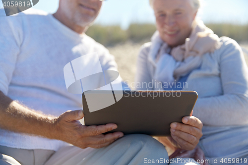 Image of close up of senior couple with tablet pc on beach