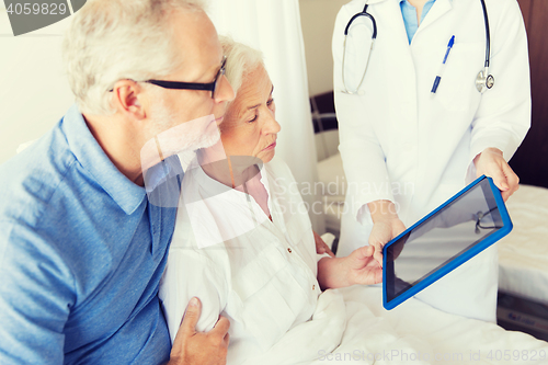 Image of senior woman and doctor with tablet pc at hospital