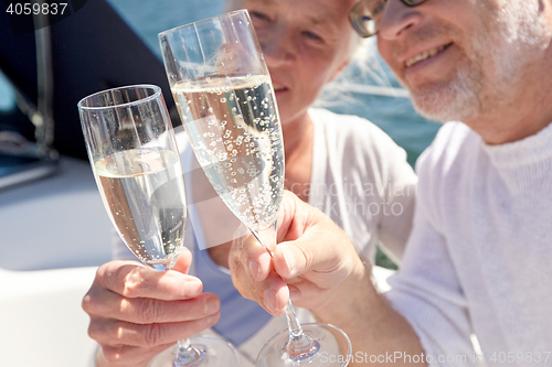 Image of close up of senior couple with champagne on boat