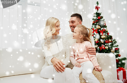 Image of happy family at home with christmas tree