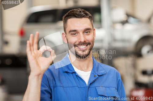 Image of auto mechanic or smith showing ok at car workshop