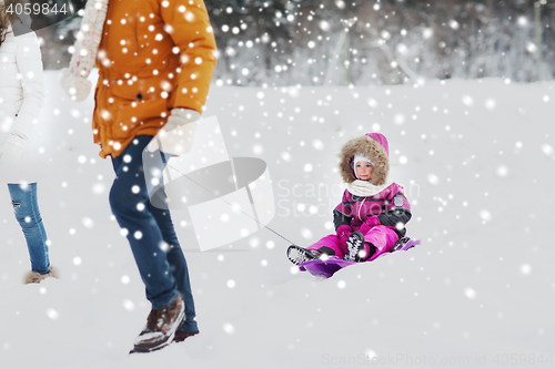 Image of happy family with sled walking in winter forest