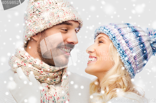 Image of smiling couple in winter clothes hugging