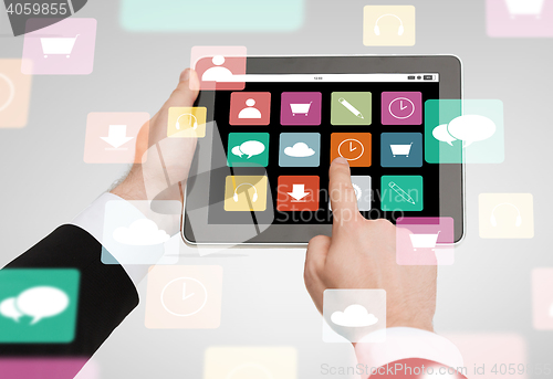 Image of close up of hands holding tablet pc with app icons