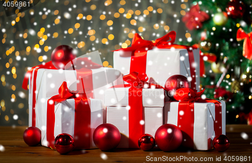 Image of gift boxes and red balls under christmas tree
